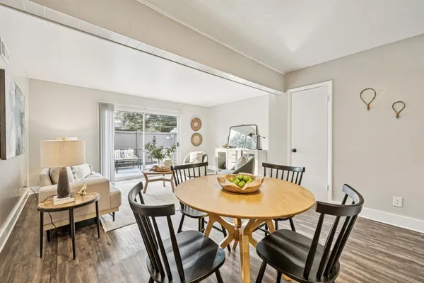 a view of a dining room with furniture and wooden floor