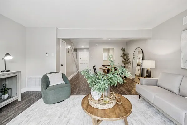 a living room with furniture potted plant and a fireplace