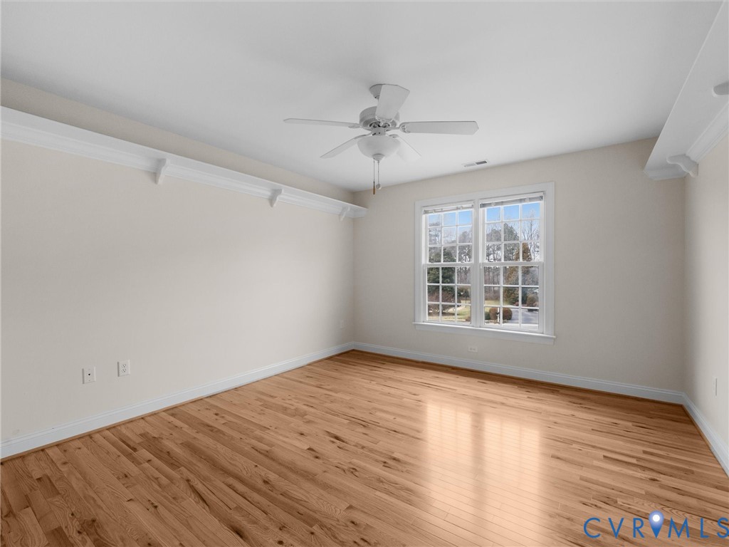 14335 Lander Road Midlothian, VA 23113 - Photo 45 of 70 an empty room with wooden floor ceiling fan and windows