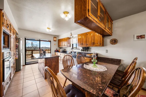 a kitchen with a table chairs and a stove