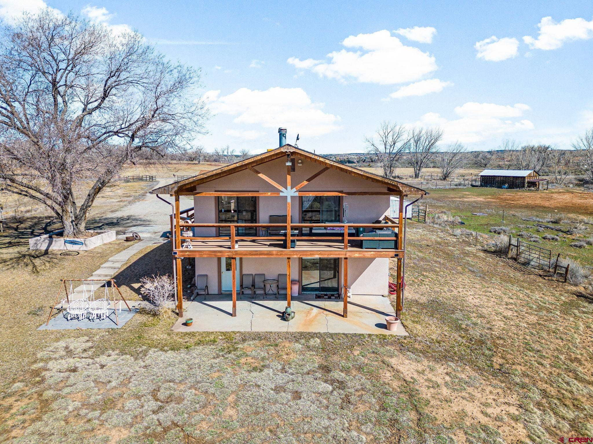 25220 County Rd M Cortez, CO 81321 - Photo 23 of 45 a view of a house with a yard and balcony