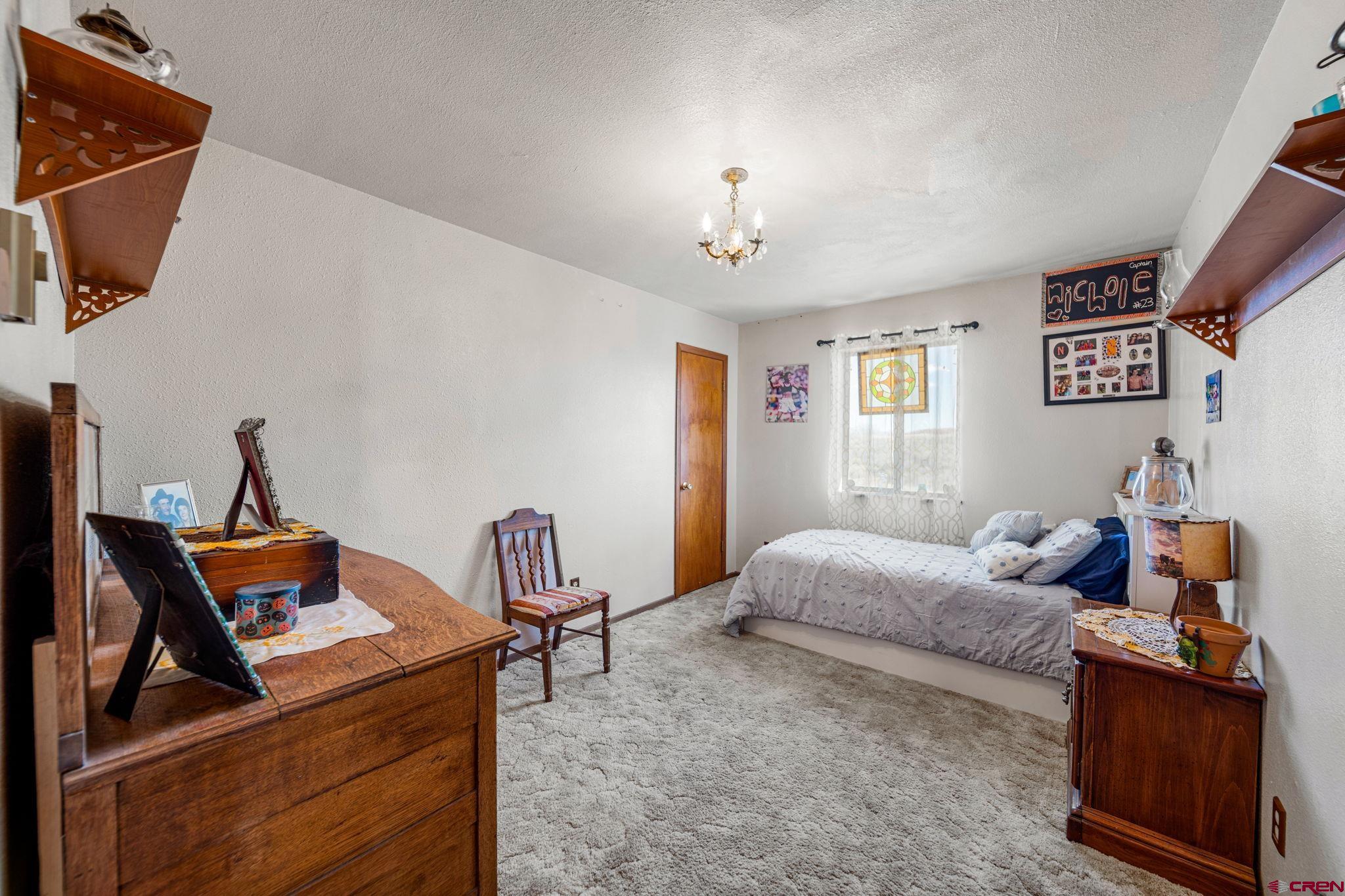 25220 County Rd M Cortez, CO 81321 - Photo 32 of 45 a bedroom with furniture and a window