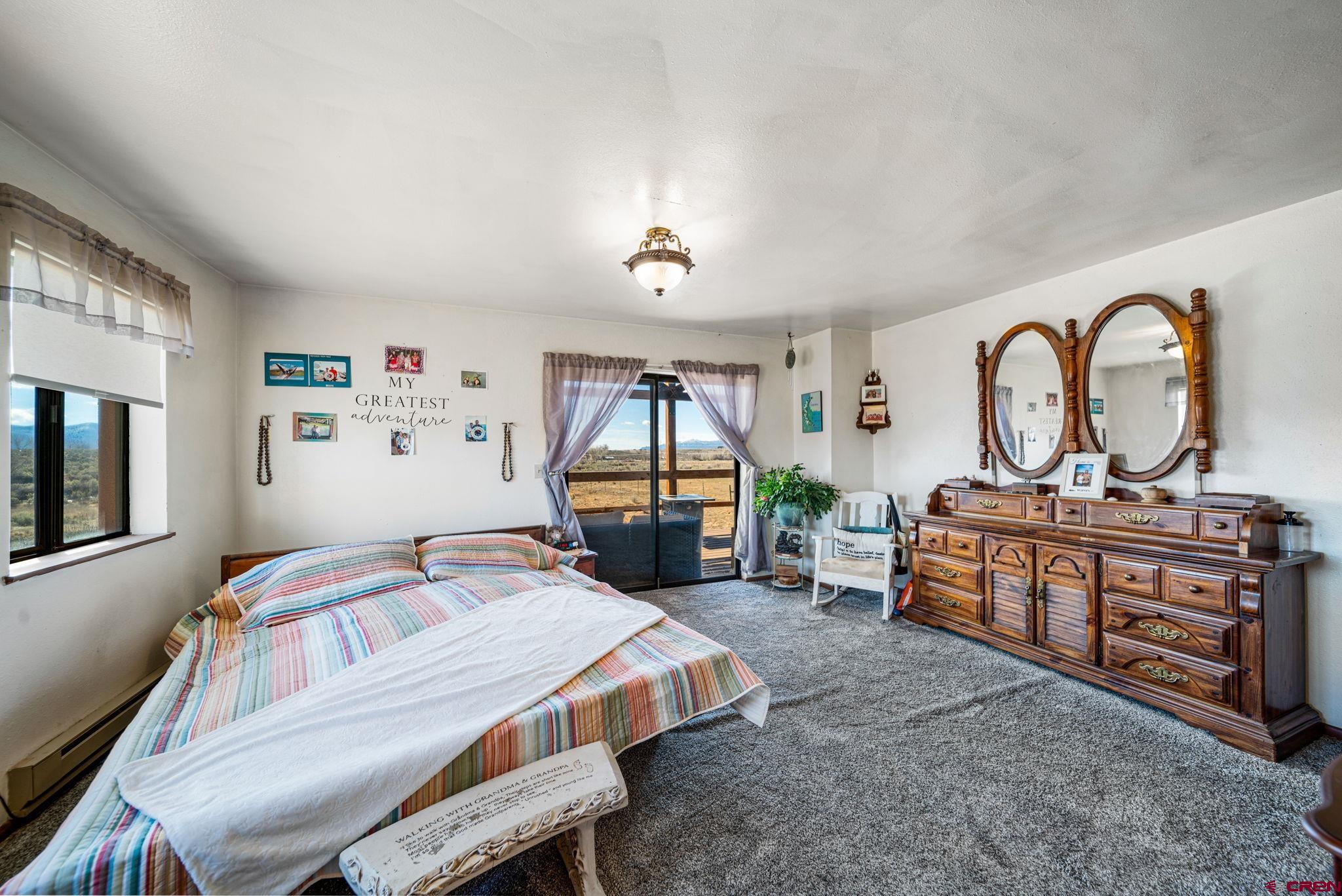 25220 County Rd M Cortez, CO 81321 - Photo 34 of 45 a bedroom with a bed and a dresser