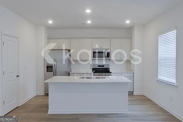 a kitchen with stainless steel appliances granite countertop a stove and a sink