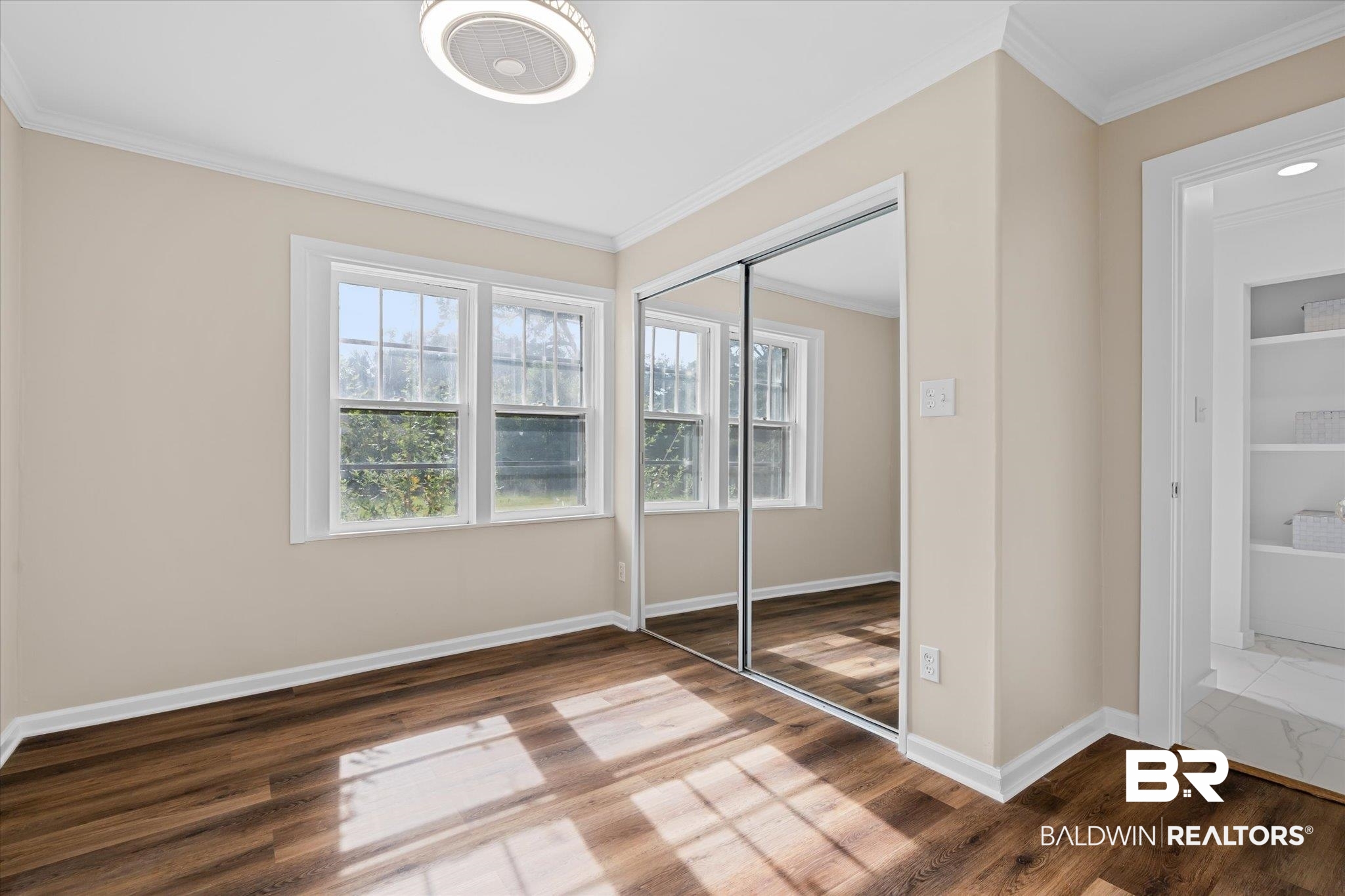 4630 General Road Mobile, AL 36619 - Photo 12 of 33 Unfurnished bedroom with hardwood / wood-style flooring, a closet, and ornamental molding