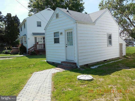 1520 Deep Point Road Woolford, MD 21677 - Photo 13 of 29 a view of a white house with a yard potted plants and a table