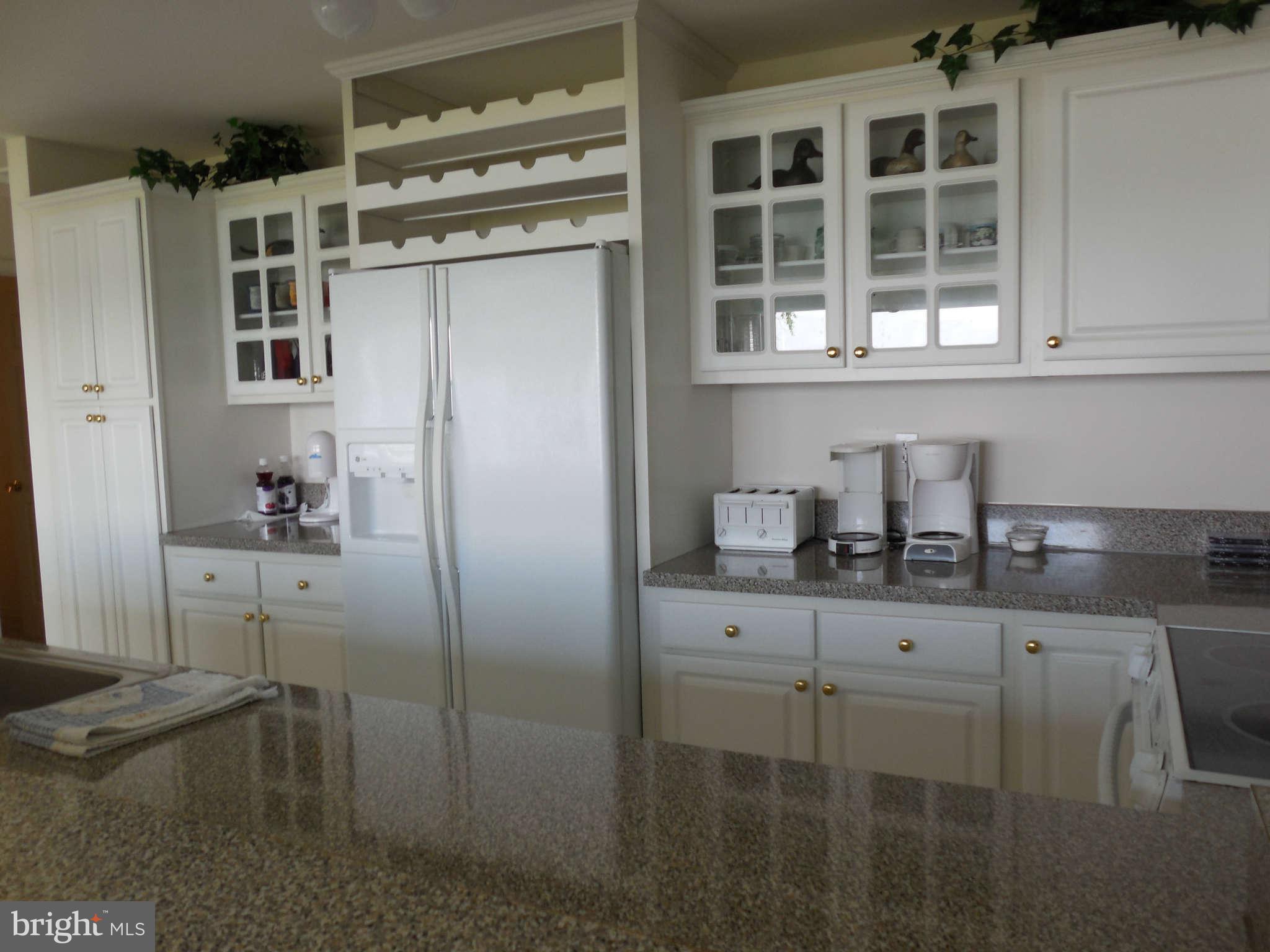 1520 Deep Point Road Woolford, MD 21677 - Photo 23 of 29 a kitchen with a refrigerator and cabinets