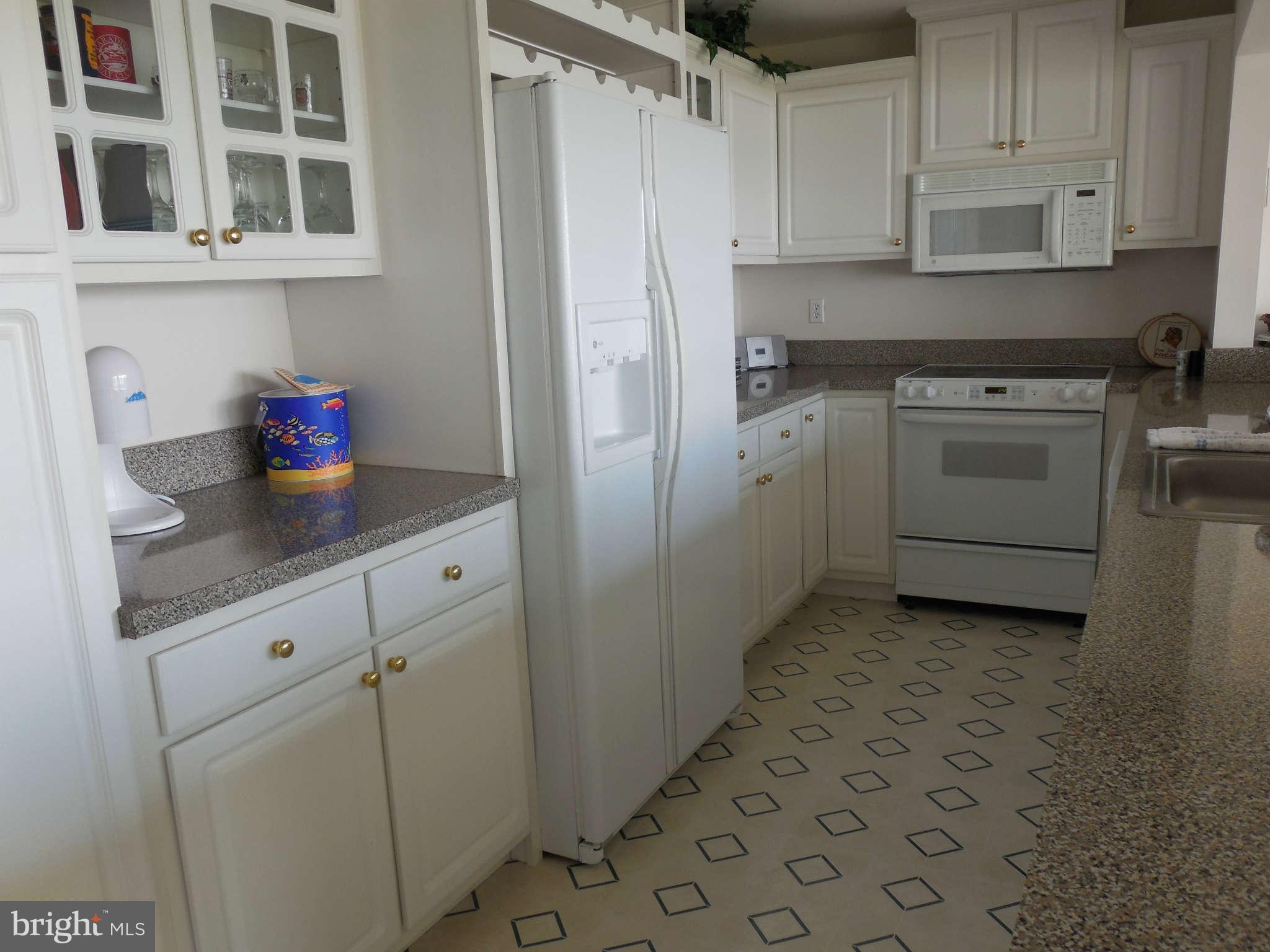 1520 Deep Point Road Woolford, MD 21677 - Photo 24 of 29 a kitchen with a stove cabinets and a refrigerator