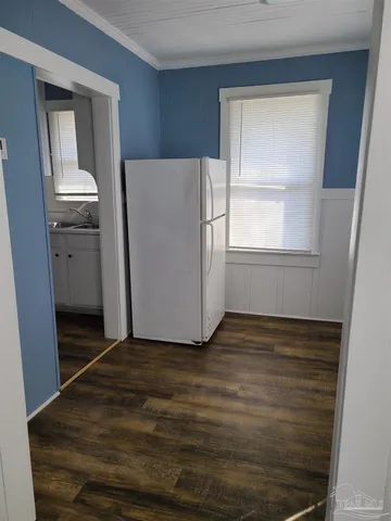 a view of empty room with window and wooden floor