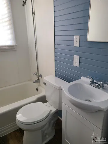 a bathroom with a sink a toilet and bathtub