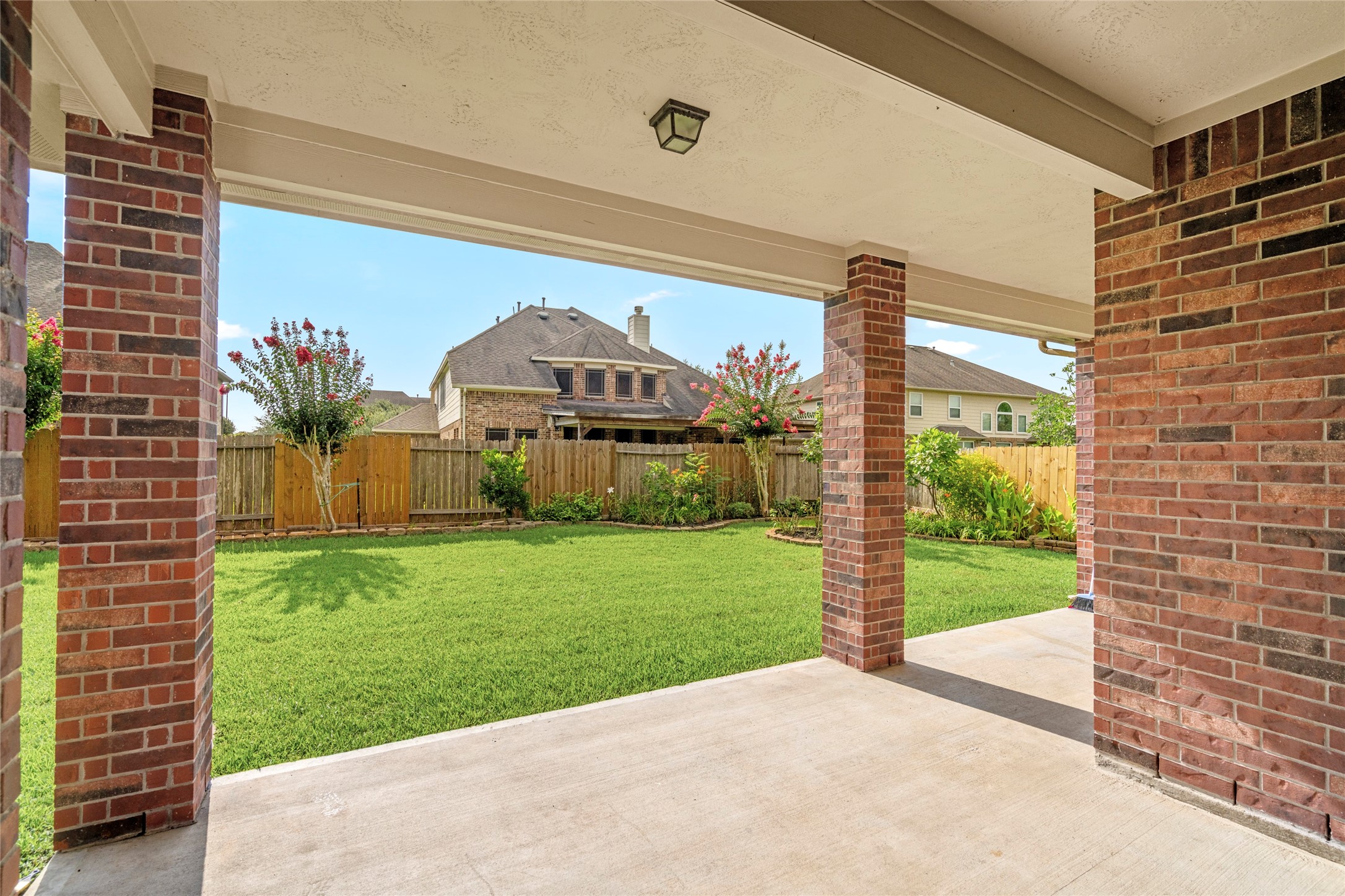 5307 Amber Sky Lane Rosharon, TX 77583 - Photo 49 of 50 A tranquil outdoor escape with lush landscaping and mature trees sets the scene for memorable evenings under the Texas sky.
