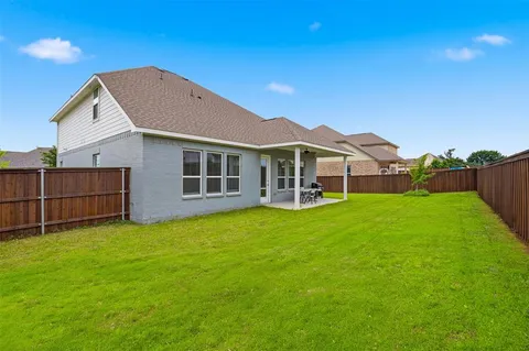 a view of a house with a yard and sitting area