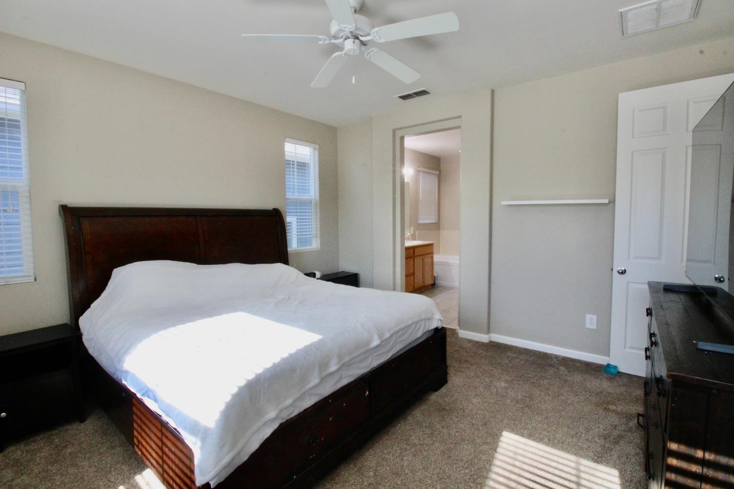 706 Annemarie Way Isleton, CA 95641 - Photo 11 of 21 a bedroom with a bed and a chandelier