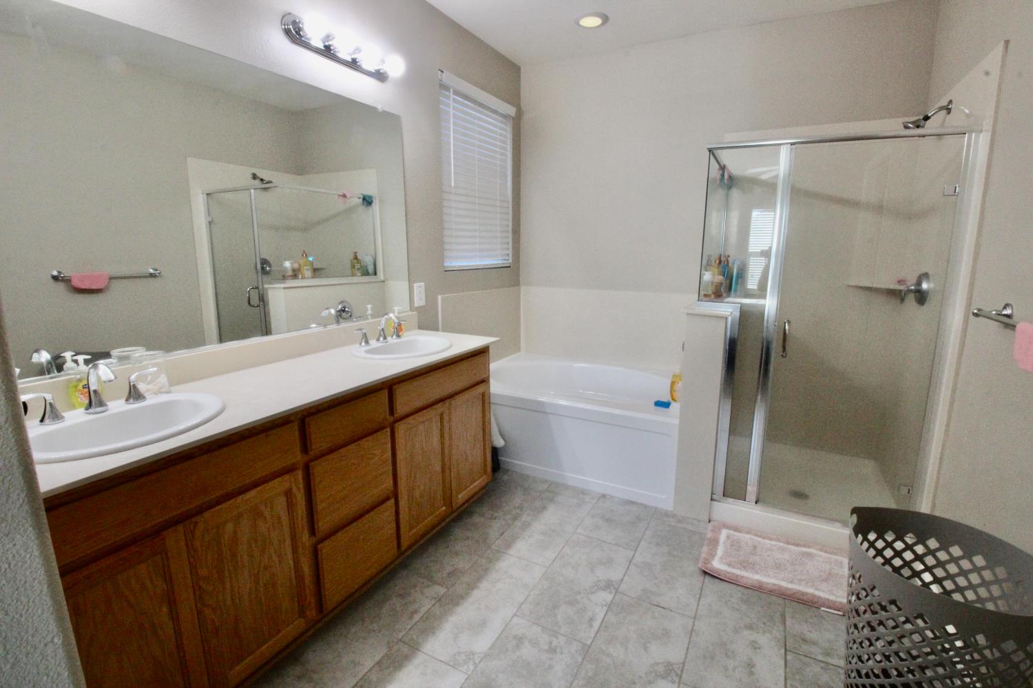 706 Annemarie Way Isleton, CA 95641 - Photo 12 of 21 a bathroom with a double vanity sink toilet mirror and shower