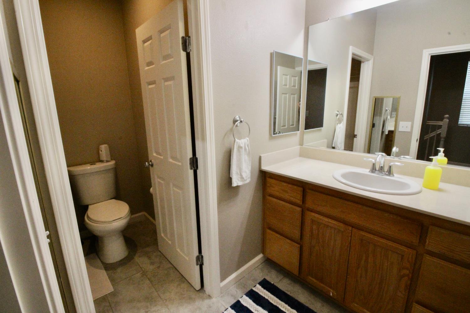 706 Annemarie Way Isleton, CA 95641 - Photo 16 of 21 a bathroom with a granite countertop toilet sink and a mirror