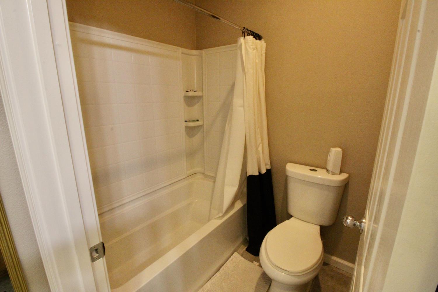 706 Annemarie Way Isleton, CA 95641 - Photo 17 of 21 a white toilet sitting next to a shower