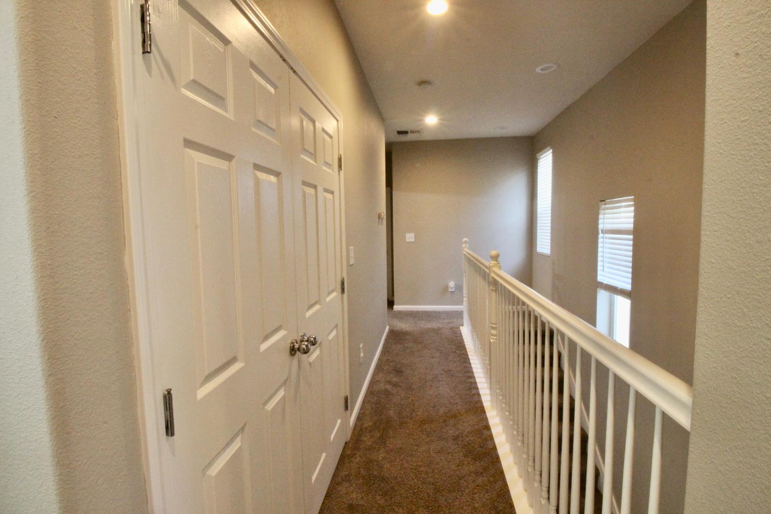 706 Annemarie Way Isleton, CA 95641 - Photo 19 of 21 a view of a hallway with wooden floor and staircase