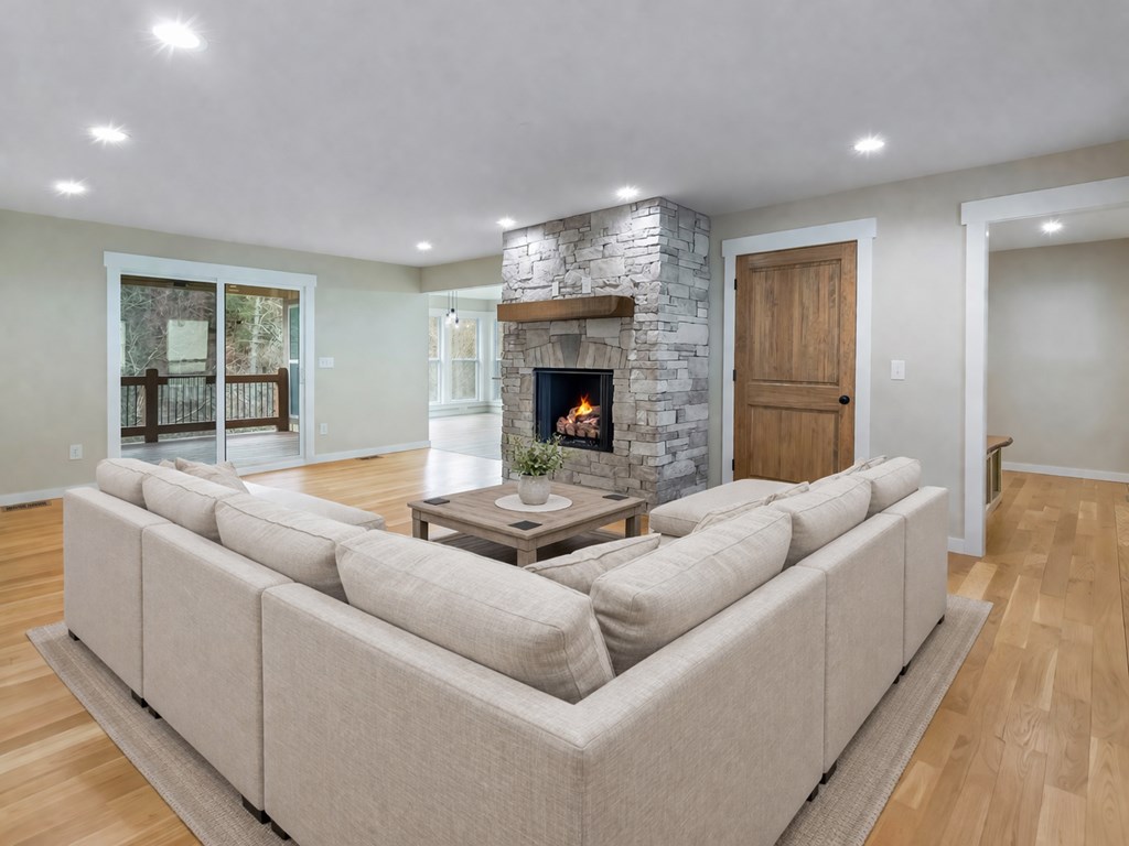 105 West Riveredge Drive Ellijay, GA 30536 - Photo 11 of 56 a living room with furniture a fireplace and a chandelier