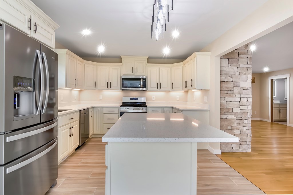 105 West Riveredge Drive Ellijay, GA 30536 - Photo 17 of 56 a large kitchen with granite countertop a large counter top stainless steel appliances and cabinets