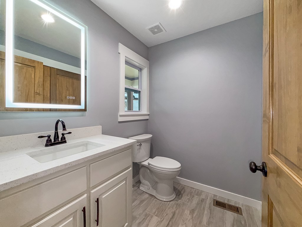 105 West Riveredge Drive Ellijay, GA 30536 - Photo 22 of 56 a bathroom with a sink toilet vanity and window