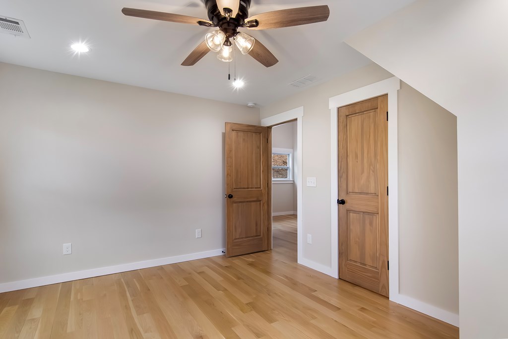 105 West Riveredge Drive Ellijay, GA 30536 - Photo 38 of 56 an empty room with wooden floor closet and fan chandelier fan