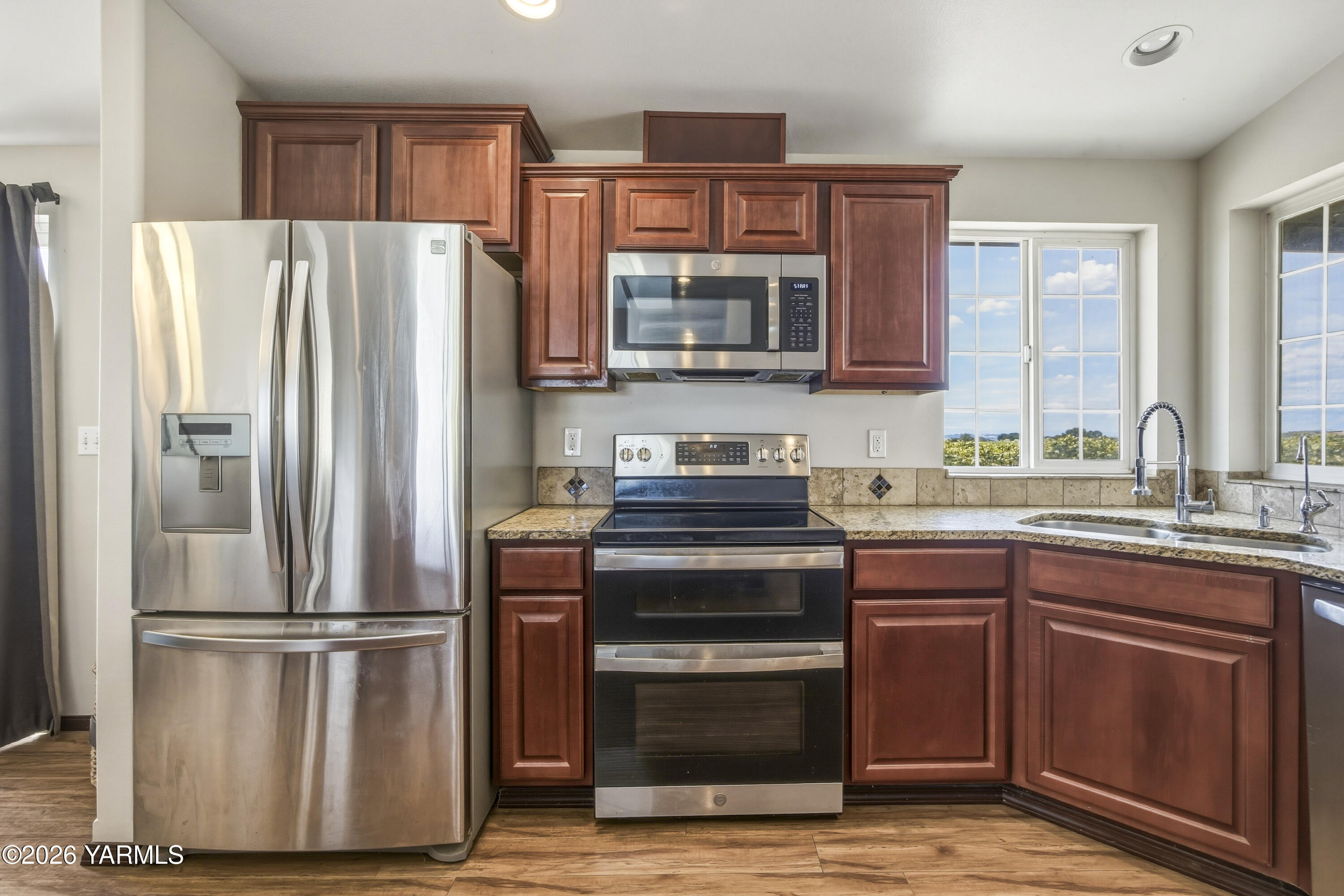 2050 Olmstead Road Grandview, WA 98930 - Photo 35 of 60 a kitchen with a refrigerator sink and microwave