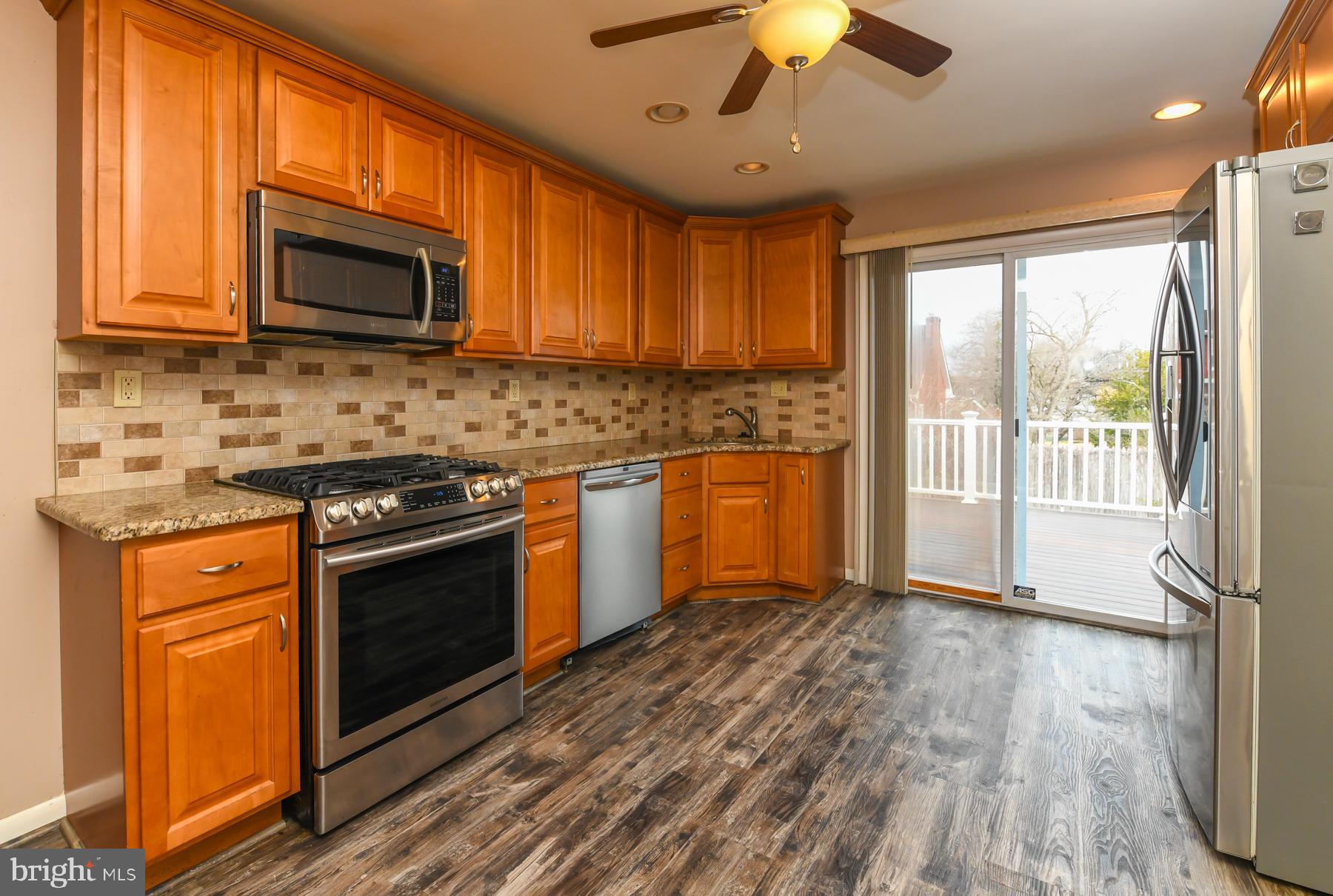 231 West Evesham Road Runnemede, NJ 08078 - Photo 8 of 23 a kitchen with stainless steel appliances granite countertop a stove a sink and a microwave