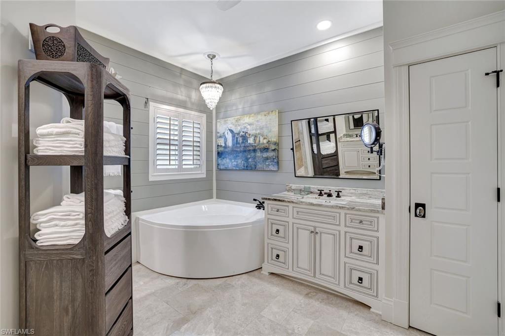 2540 Talon Court, Unit 504 Naples, FL 34105 - Photo 17 of 31 Full bathroom with a soaking tub, walk-in shower and two updated vanities.