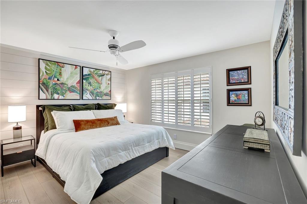 2540 Talon Court, Unit 504 Naples, FL 34105 - Photo 19 of 31 Bedroom with shiplap walls, nice light, custom closet system. Reclaimed wood floors.