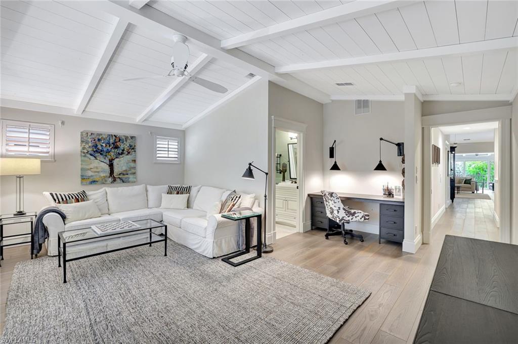 2540 Talon Court, Unit 504 Naples, FL 34105 - Photo 21 of 31 3rd bedroom currently used as media room w/vaulted beamed ceilings, ensuite bath, designated closet area has a built-in desk (could easily be converted back to a closet).