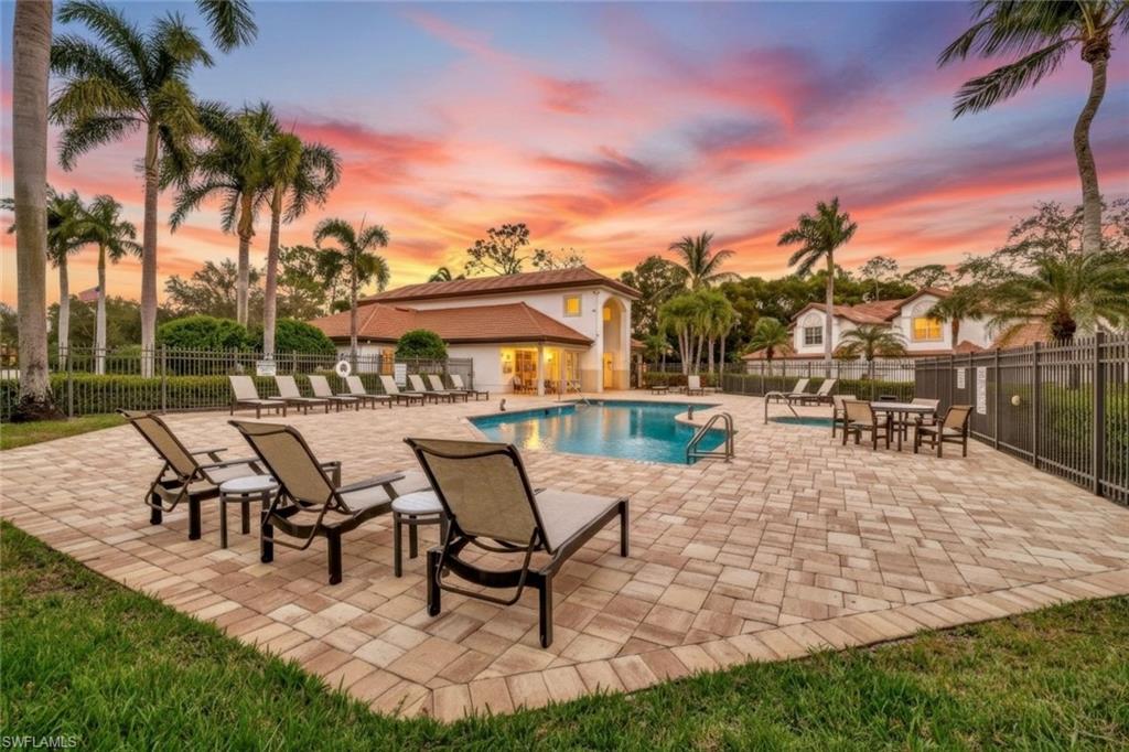 2540 Talon Court, Unit 504 Naples, FL 34105 - Photo 23 of 31 Pool at dusk with a patio area and a community pool