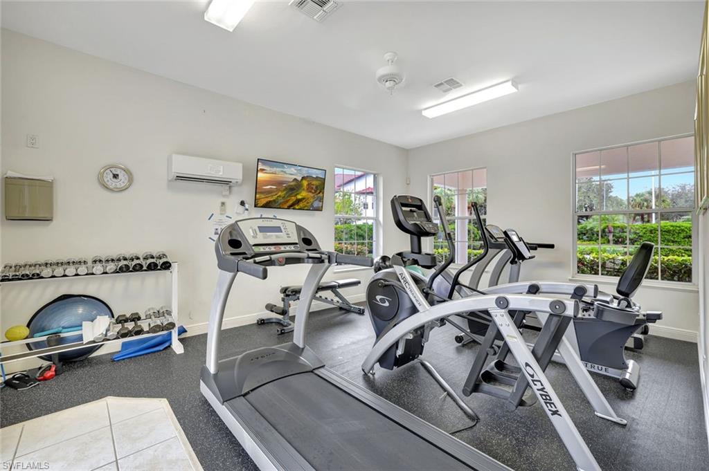 2540 Talon Court, Unit 504 Naples, FL 34105 - Photo 28 of 31 Exercise room featuring a wall unit AC
