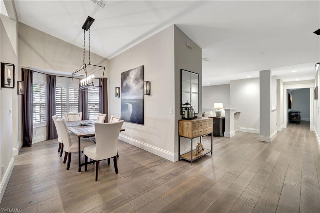 2540 Talon Court, Unit 504 Naples, FL 34105 - Photo 8 of 31 Dining area with bay window, 4 wall sconces and lovely chandelier