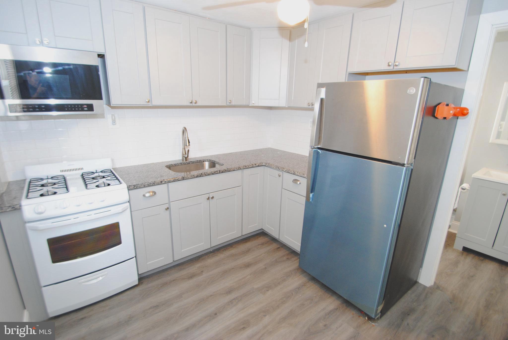 374 Farnsworth Avenue Bordentown, NJ 08505 - Photo 3 of 7 a kitchen with a refrigerator sink and cabinets