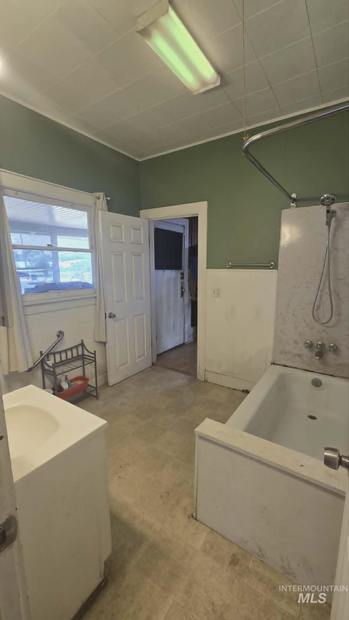 1212 Main Street Pomeroy, WA 99347 - Photo 12 of 18 Bathroom with a built-in tub, white vanity with integrated sink, and linoleum flooring