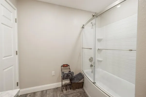 a bathroom with a tub a sink and a shower