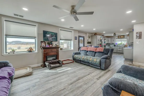 a living room with furniture and kitchen view