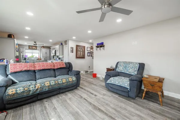 a living room with furniture and kitchen view