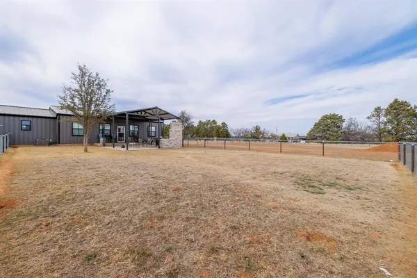 a view of swimming pool with outdoor seating and covered with trees