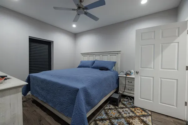 a bedroom with a bed and a chandelier