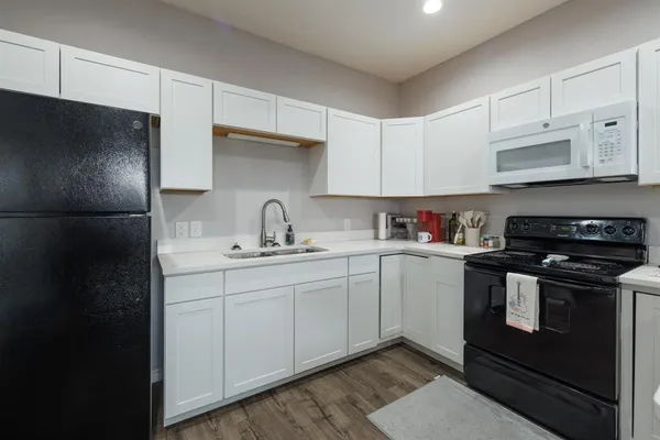 a kitchen with stainless steel appliances a sink stove and refrigerator