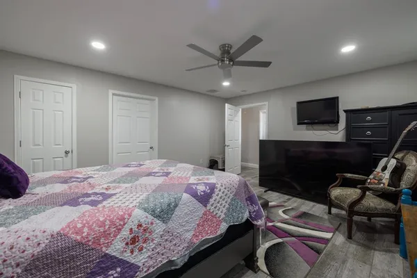 a bedroom with a bed and a television