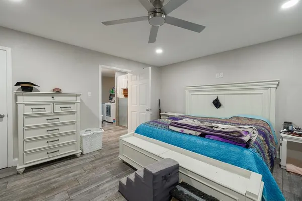 a bedroom with a bed and cabinet