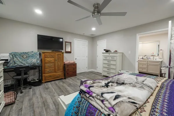 a bedroom with a bed and a television