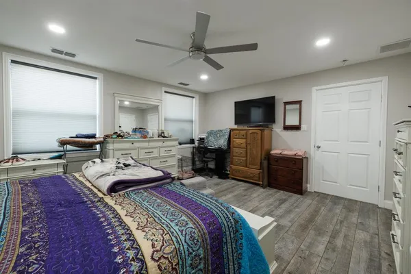 a bed room with a bed and a television