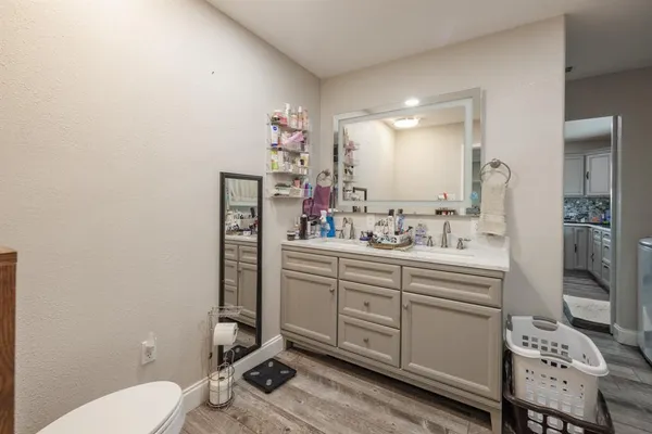 a bathroom with a sink mirror vanity and toilet