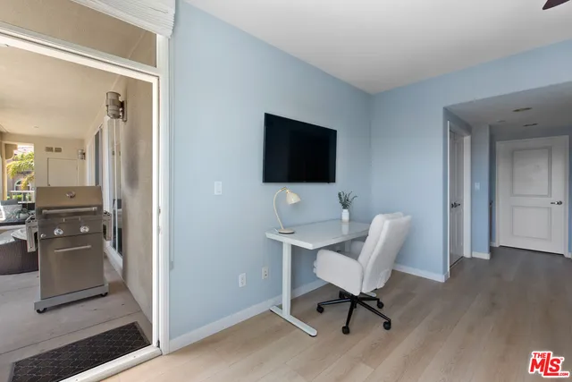 a work room with furniture and a flat screen tv
