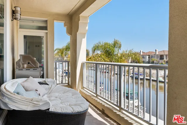 a dining room with furniture and a floor to ceiling window