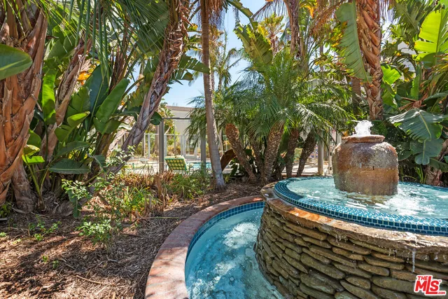 a view of a water fountain in front of a house