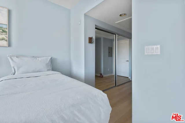 a bedroom with a bed and a mirror